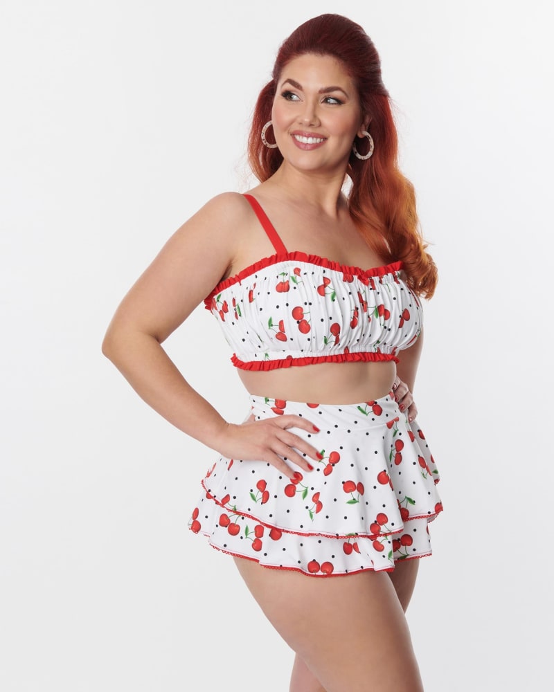 Front of a model wearing a size 3X/20 Unique Vintage Plus Size White & Cherry Pin Dot Ruffle Swim Bottom in White & Cherry Pin Dot by Unique Vintage. | dia_product_style_image_id:269503